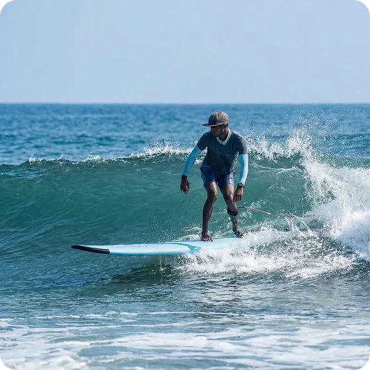 Surf instructor teaching a beginner surfing in Arugam Bay, Sri Lanka
