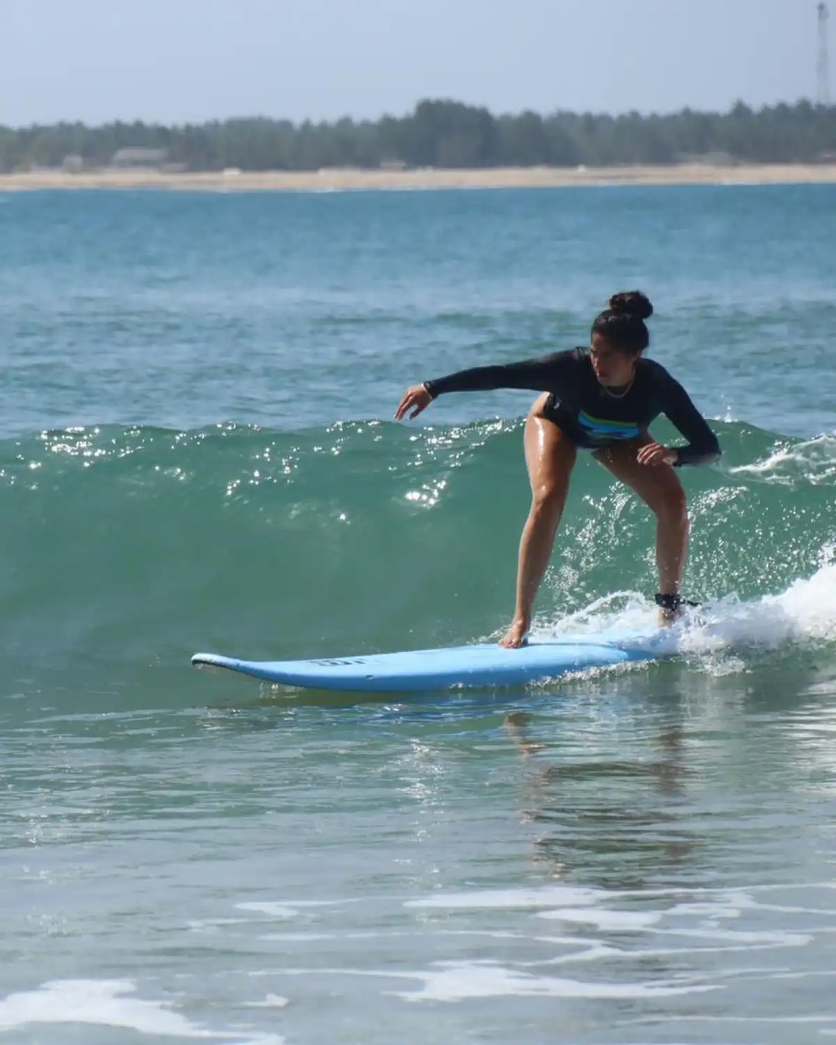 girl catching a wave in surf lesson in Arugam bay Srilanka