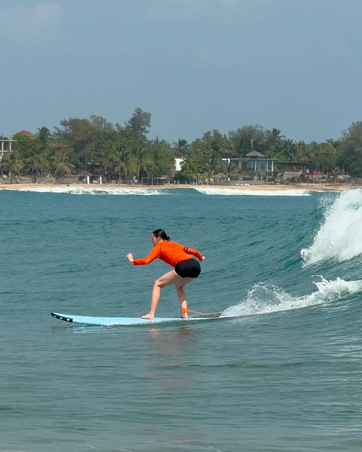 Girl surfing lesson in Arugam bay Srilanka